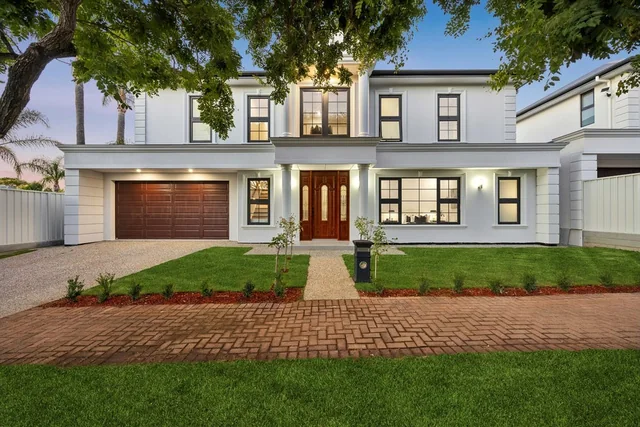 Two-storey home with columned entrance and landscaped garden